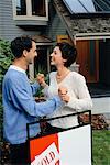 Couple In Front of House, With Sold Sign