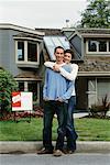 Couple Standing in Front of New House