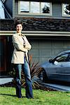 Woman Standing in Front of New Car and House