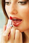 Young Woman Applying Lipstick