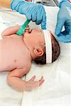 Hands Measuring Newborn's Head