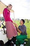 Man Proposing to Woman at Golf Course