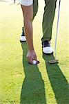 Golfer Taking Ball from Cup