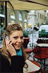 Woman Using Cell Phone at Cafe