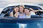 Women in Car, Taking Pictures With Camera Phone