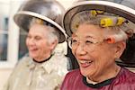 Women with Hair Curlers Under Dryers