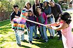 Family Playing with Pinata in Backyard