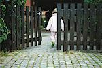 Girl Walking Through Gate