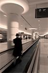 Man on Moving Sidewalk in Airport