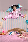 Girl Jumping on Bed