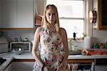 Portrait of Woman Standing In Kitchen