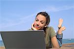 Woman Lying on Dock, Using Laptop