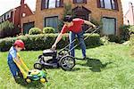 Father and Son Mowing Lawn