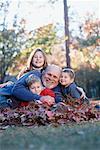 Children with Grandfather in Fall Leaves