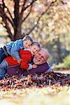 Grandfather and Grandsons Outdoors in Autumn