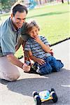 Father and Son Playing With Remote Controlled Car