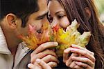 Couple se cachant derrière les feuilles