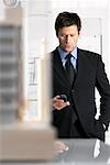Businessman Looking at Cellular Phone