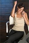 Woman Talking On Cell Phone At Desk
