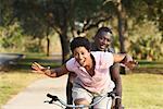 Couple Riding Tandem Bicycle