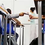 Students Passing A Note in the Classroom