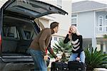 Couple Packing Luggage in SUV