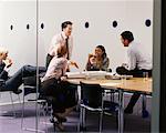 Business People Eating Pizza in Boardroom