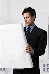 Businessman Looking at Floor Plans