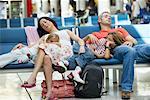 Family Sleeping in Airport Waiting Area