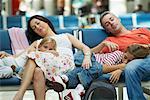 Family Sleeping in Airport Waiting Area