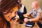 Businesswoman in Meeting, Using Cellular Phone