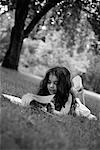 Girl Lying on Grass Reading