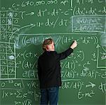 Man Writing on Chalkboard