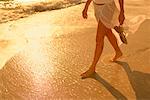 Woman Walking along Beach