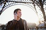 Man on Cell Phone in Front of Eiffel Tower, Paris, France