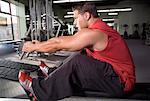 Man Using Weight Machine In Gym