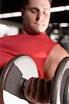 Man Using Dumb-bell In Gym