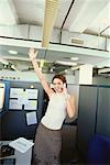 Businesswoman Using Cell Phone in Office