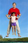 Father and Daughter on Trampoline