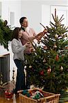 Mother and Daughter Decorating Christmas Tree