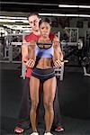 Woman Lifting Weights with Personal Trainer