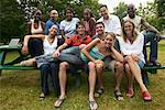 Group Portrait of People Sitting on Picnic Table