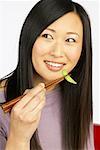 Woman Eating with Chopsticks
