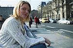 Woman Sitting on Curb Smoking Cigarette, Paris, France