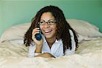 Woman on Bed with Cellular Phone