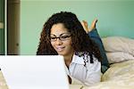 Woman on Bed with Laptop Computer