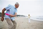 Couple Playing Frisbee on the Beach