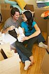 Couple Eating Take-Out Food On The Floor On Moving Day