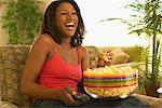 Woman Eating Popcorn and Watching Television