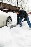 Man Removing Snow from Car